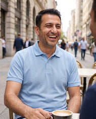 Light blue polo, seated
